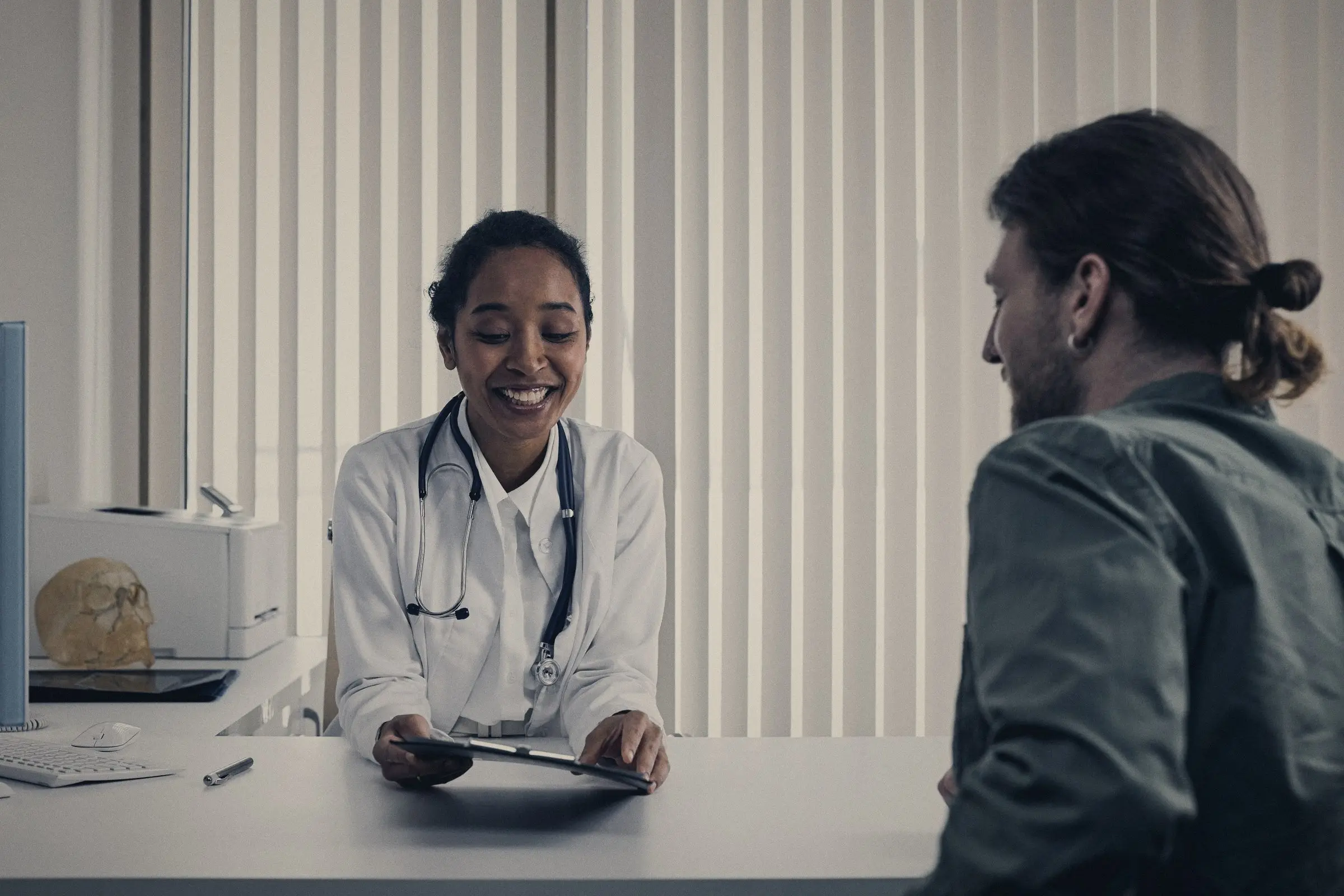 Médica atendiendo a un paciente durante una consulta